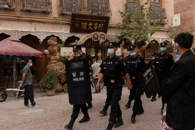 In China's new Xinjiang: patriotic tourism, police and propaganda