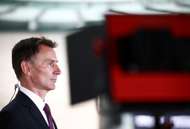 British Chancellor of the Exchequer Jeremy Hunt talks to a television crew outside the BBC headquarters in London