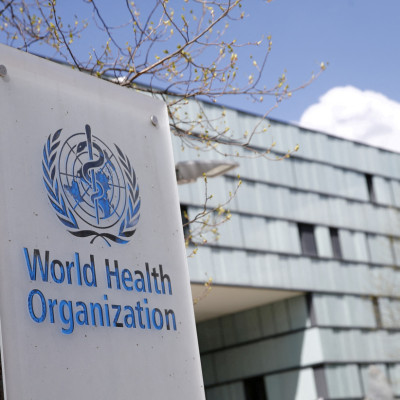 A logo is pictured outside a building of the WHO in Geneva