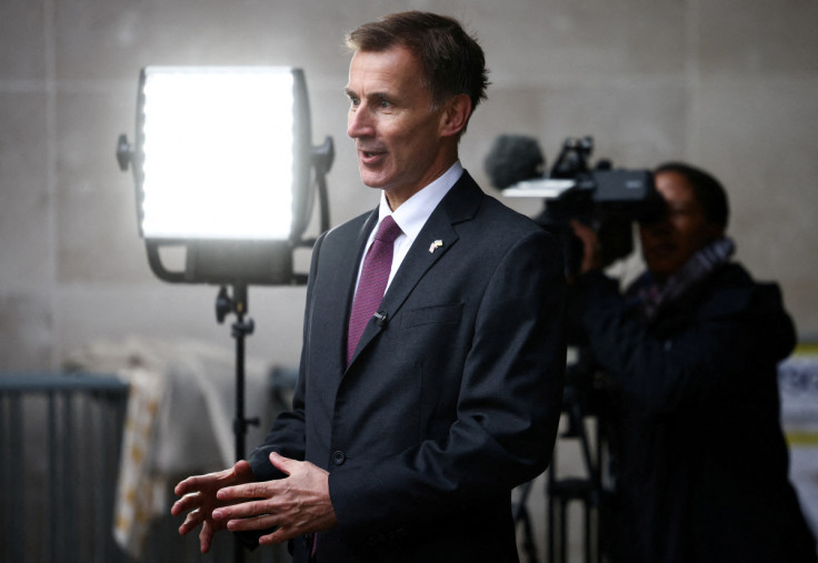 British Chancellor of the Exchequer Jeremy Hunt talks to a television crew outside the BBC headquarters in London