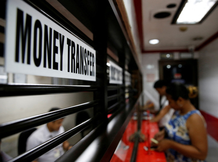 Customers receive money from families working abroad at a money remittance center in Makati