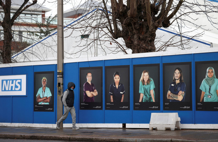 Images of National Health Service (NHS) workers displayed on hoardings outside a temporary field hospital at St George's Hospital in London