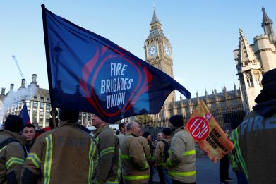 Members of the Fire Brigades Union take part in a rally regarding possible future strike action linked to a pay dispute, in London
