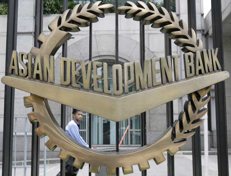 A worker walks past inside the Asian Development Bank headquarters in Manila