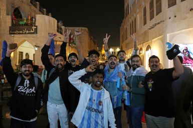 Supporters in Doha's Souq Wafiq celebrate Argentina's first goal of the World Cup final