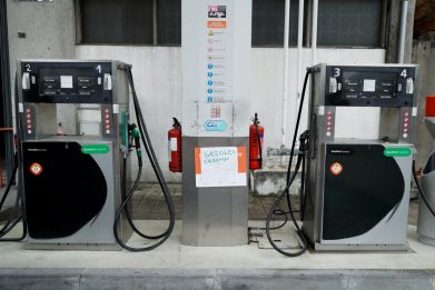 A placard reading "Diesel sold out" is seen at a gas station in Porto