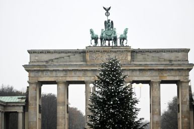 Activists sawed the top two metres off the 15-metre Christmas tree in front of Berlin's iconic Brandenburg Gate