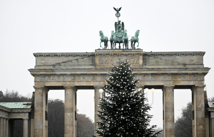 Activists sawed the top two metres off the 15-metre Christmas tree in front of Berlin's iconic Brandenburg Gate