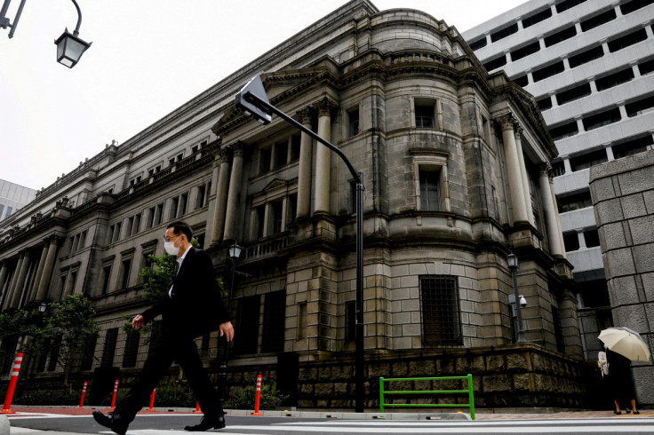 A man wearing a protective mask walks past the headquarters of Bank of Japan amid the coronavirus disease (COVID-19) outbreak in Tokyo