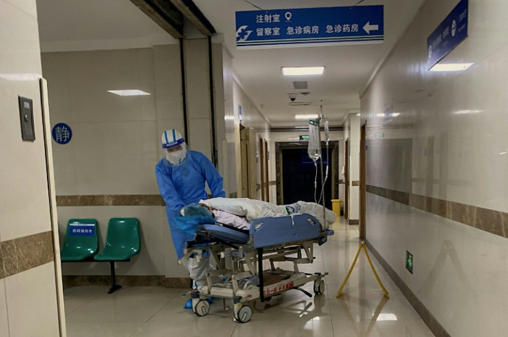 The staff at the Chongqing hospital had their hands full, ferrying elderly patients to different wards as families and other visitors hovered anxiously
