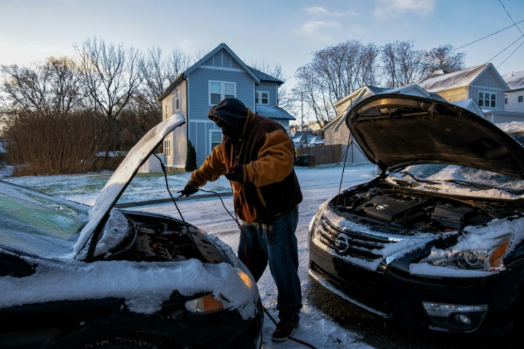 Antonio Smothers jump-starts his vehicle as a major winter storm moves through Nashville, Tennessee on December 23, 2022