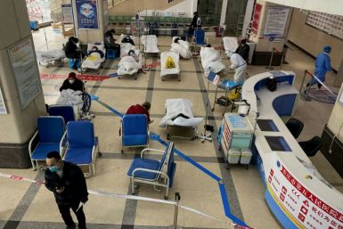 Covid-19 patients lie on hospital beds in a cordoned off area in the lobby of the Chongqing No. 5 People's Hospital in China's southwestern city of Chongqing on December 23, 2022