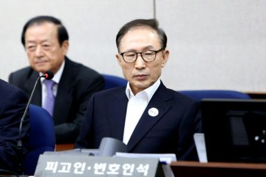 Former president Lee Myung-bak (R, pictured during his trial in 2018) was serving 17 years for  bribery and embezzlement during his time in office