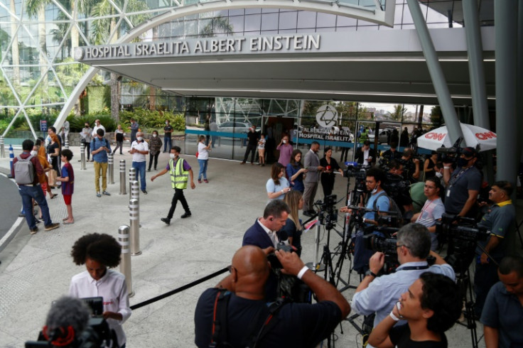 People wait at the Albert Einstein Israelite Hospital, where Brazilian football legend Pele died after a long battle with cancer, in Sao Paulo on December 29, 2022