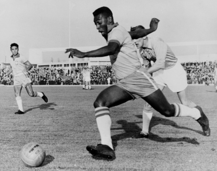 In this photo taken on May 8, 1960, Brazilian football legend Pele dribbles past a defender during a friendly match between Malmo and Brazil, in Sweden