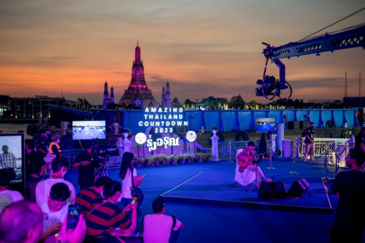 A performer sings during New Year countdown celebrations along the Chao Phraya River in Bangkok