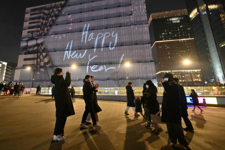 People enjoy the last day of the year on New Year's Eve at Gwanghwamun square in central Seoul on December 31, 2022
