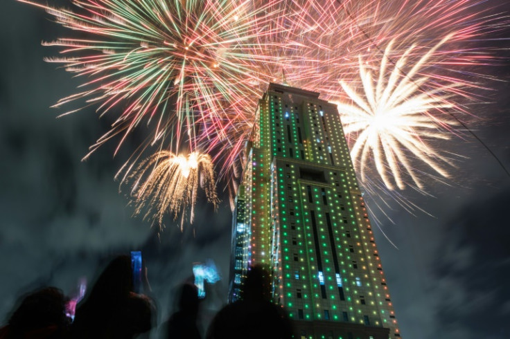 People look at fireworks launching from the building of Old Mutual Tower to celebrate the new year in Nairobi on January 1, 2023