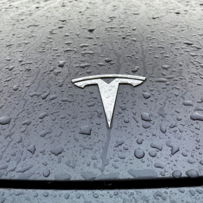 A view shows the Tesla logo on the hood of a car in Oslo