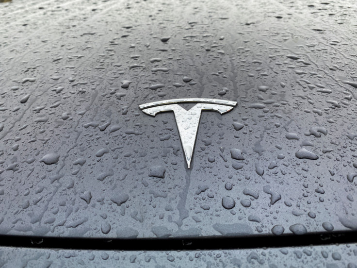 A view shows the Tesla logo on the hood of a car in Oslo