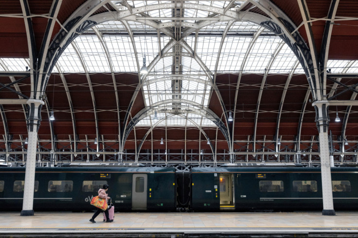 A passenger walks past a GWR train at Paddington Station in London