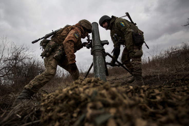 Ukrainian servicemen set up a mortar for firing it towards positions of Russian troops, in the outskirts of Bakhmut