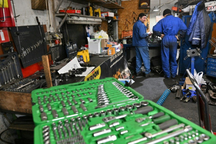 The mechanics tuning up used cars for a turn on the battlefield see their job as an important contribution to the war