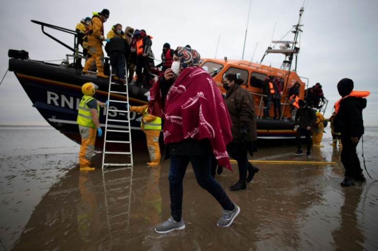 Migrants are helped ashore by a lifeboat at a beach in southeast England in December 2021