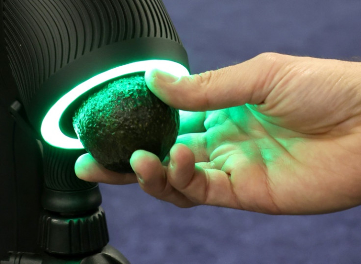 The OneThird Ripeness Checker is demonstrated checking an avocado during a press event at CES 2023