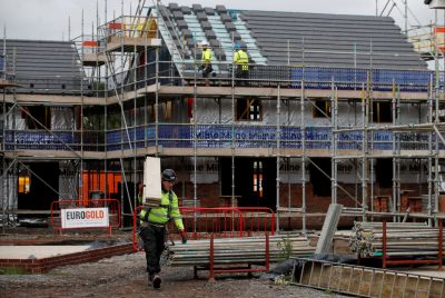Builders work on a new Barratt Homes housing development near Warrington, Britain