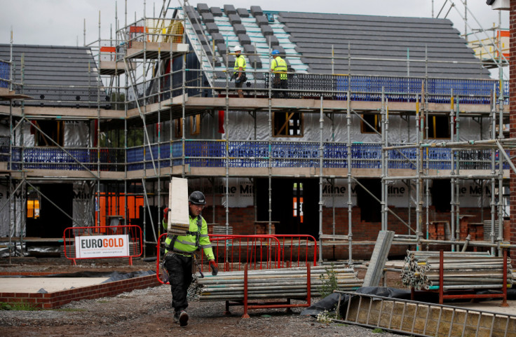 Builders work on a new Barratt Homes housing development near Warrington, Britain