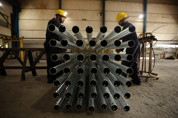 Workers adjust a consignment of freshly galvanised street lamps inside the factory of Corbetts The Galvanizers in Telford