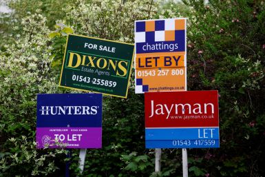 Property estate agent sales and letting signs are seen outside a building
