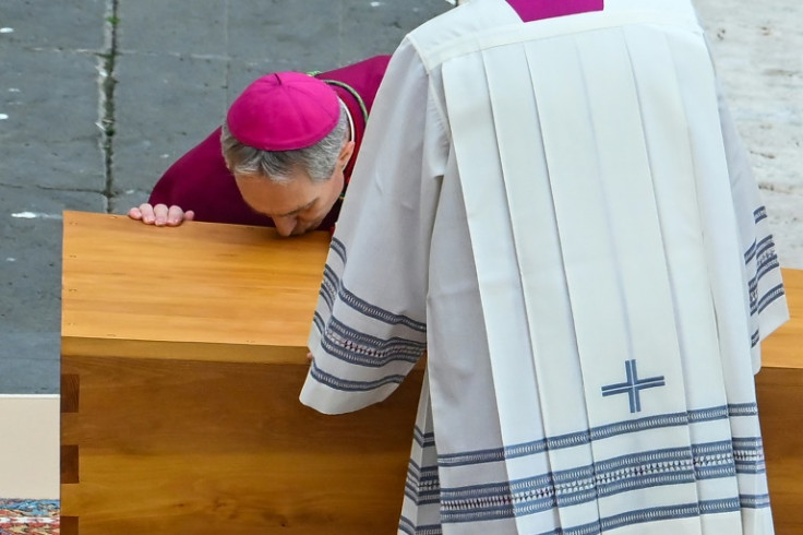 German Archbishop Georg Gaenswein kisses the coffin of Pope Emeritus Benedict XVI at the start of his funeral mass at St. Peter's square in the Vatican, on January 5