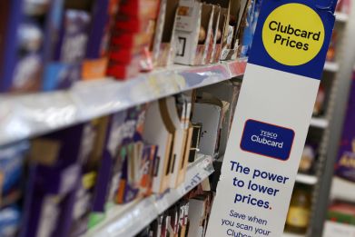 Clubcard branding is seen inside a branch of a Tesco Extra supermarket in London