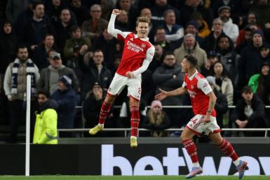 Soaring clear: Martin Odegaard (centre) scored as Arsenal moved eight points clear at the top of the Premier League