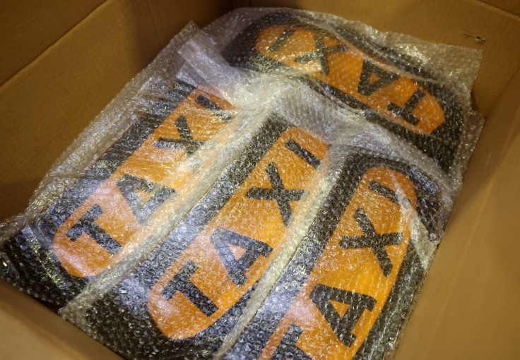 New taxi signs are seen inside a cardboard box on the TX electric taxi production line inside the LEVC (London Electric Vehicle Company) factory in Coventry