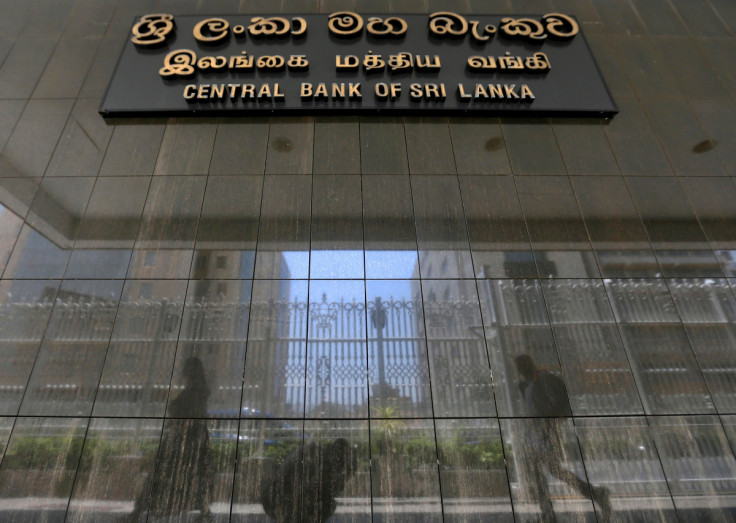 People walk past the main entrance of the Sri Lanka's Central Bank in Colombo, Sri Lanka