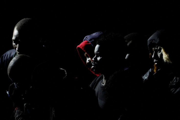 Migrants wait to disembark from a Spanish coast guard vessel, in the port of Arguineguin