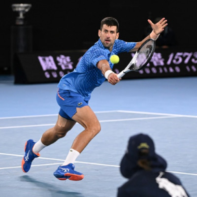 Serbia's Novak Djokovic hits a return against Greece's Stefanos Tsitsipas