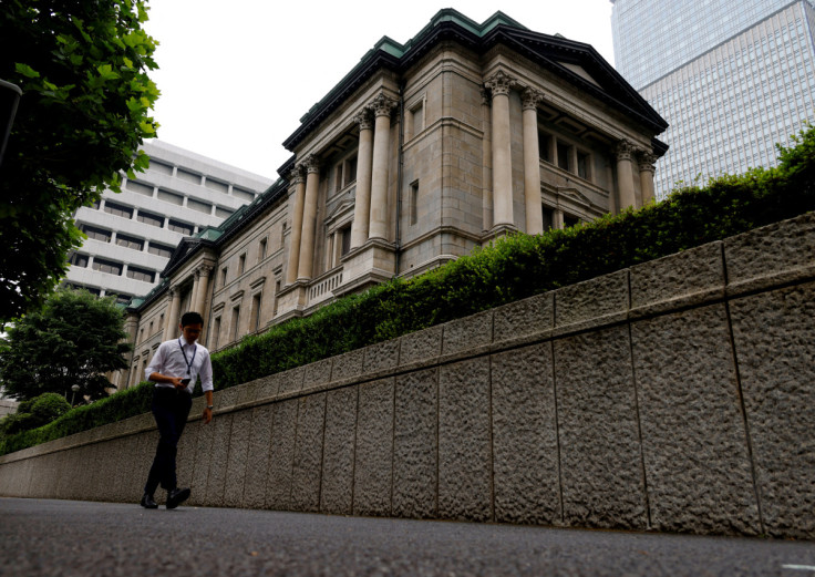 A man walks past Bank of Japan's headquarters in Tokyo