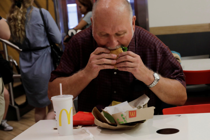 A man eats his meal inside of a McDonald's restaurant in New York