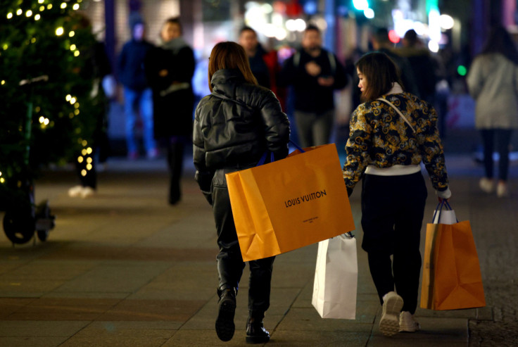 Women with shopping bags branded with Louis Vuitton walk outside the department store "KaDeWe" in Berlin