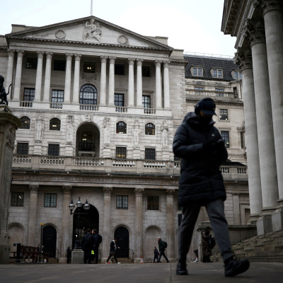 People walk outside the Bank of England in the City of London financial district