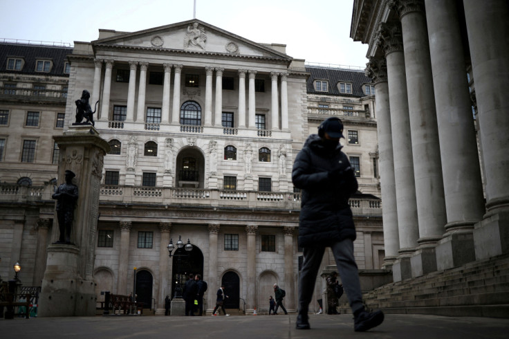 People walk outside the Bank of England in the City of London financial district