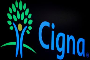 A screen displays the logo for Cigna Corp. on the floor at the NYSE in New York