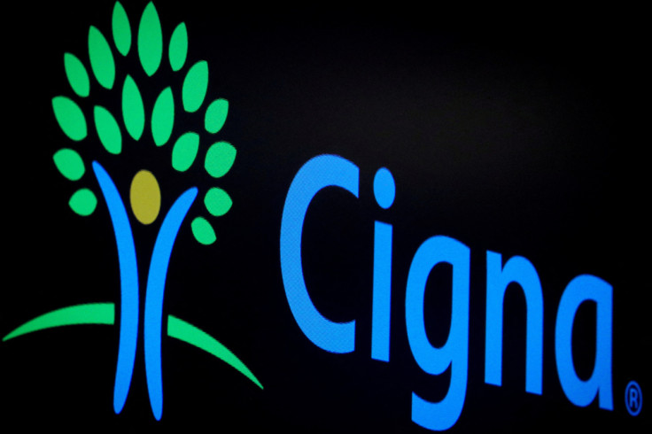 A screen displays the logo for Cigna Corp. on the floor at the NYSE in New York