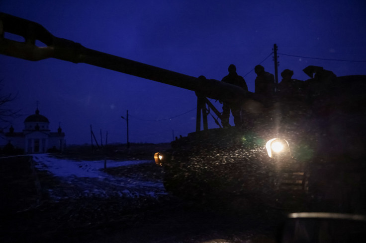 Ukrainian servicemen stand at a self-propelled howitzer near the frontline town of Toretsk
