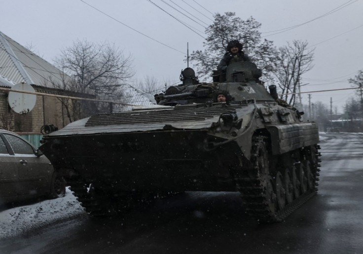 Ukrainian service members ride a BMP-1 infantry fighting vehicle near the frontline town of Bakmut