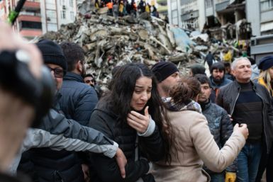 Rescuers search for survivors through the rubble of collapsed buildings in Turkey